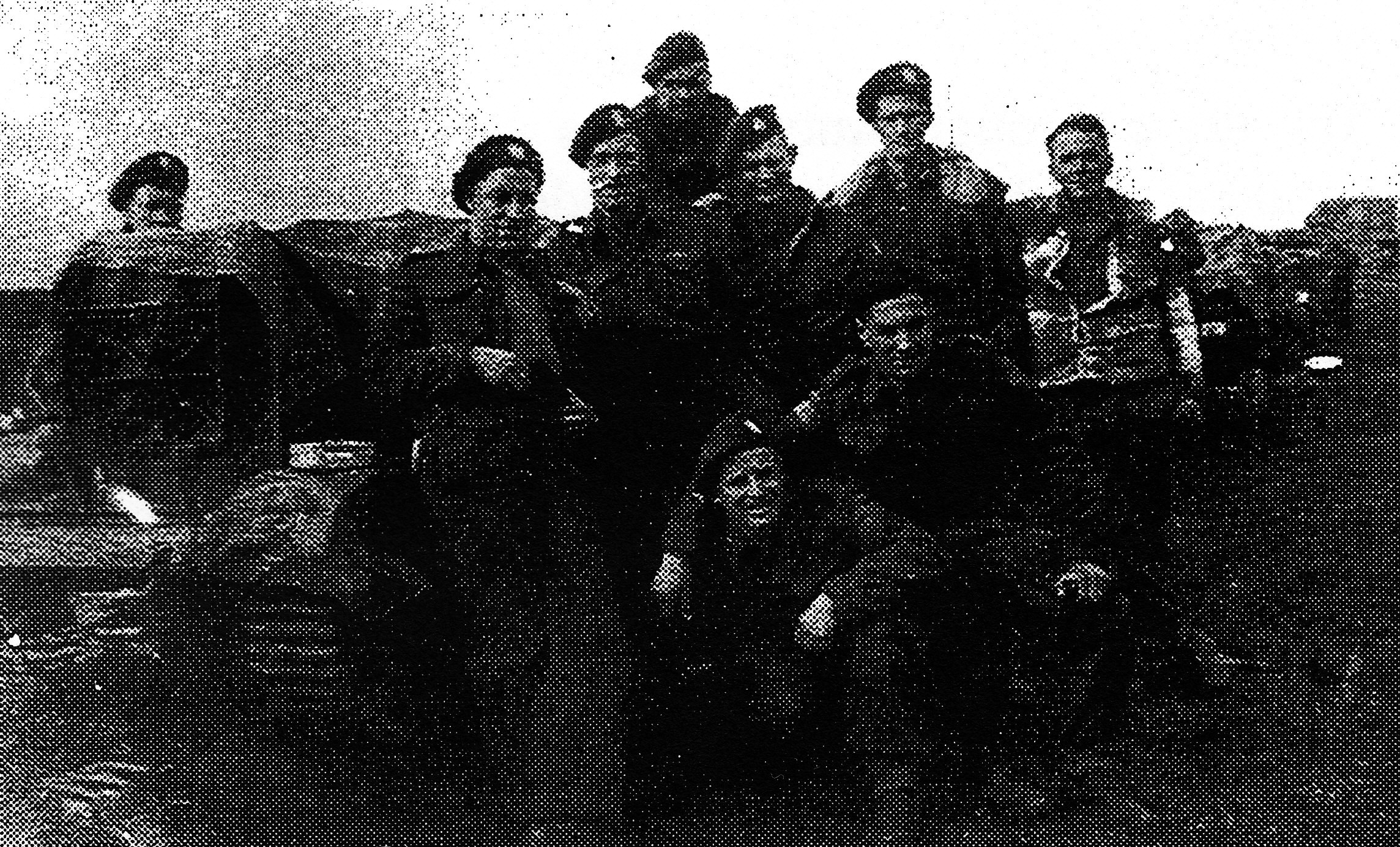 John Marin eight other soldiers posing beside a tracked vehicle